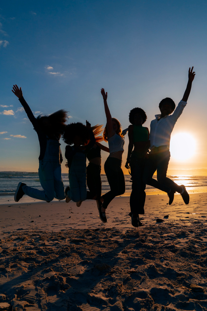 Community of people celebrating hope and recovery at sunset