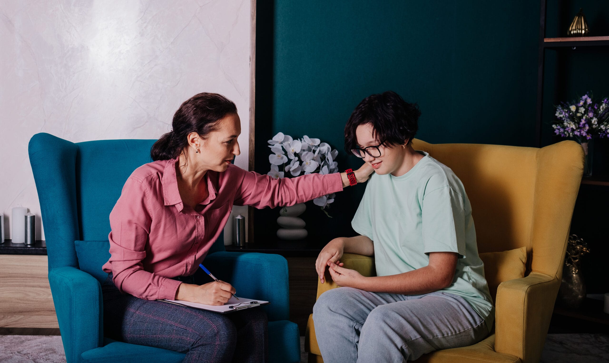 A supportive moment between a practitioner and a young client, representing the first confidential call about working with an interventionist in Los Angeles